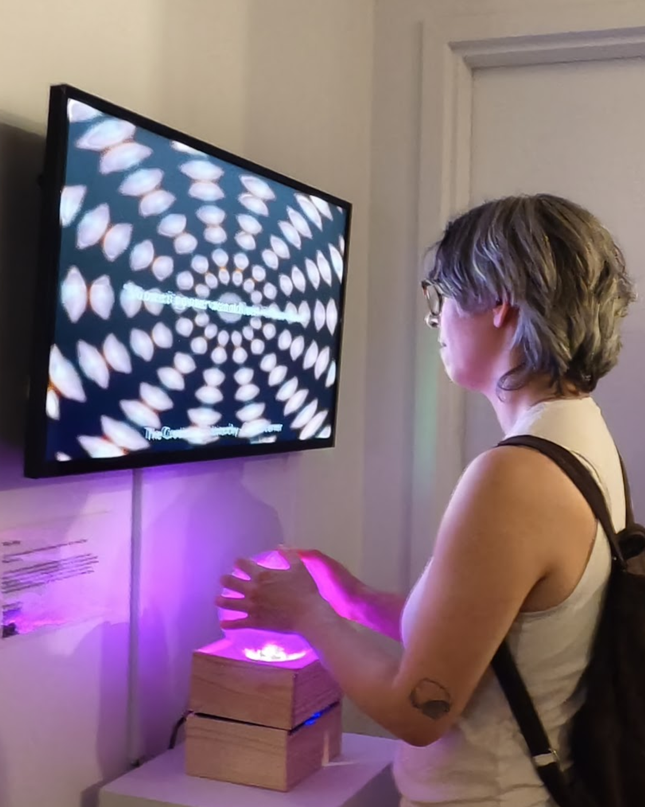 Multiple visitors gathered around Vibe Altar interactive sculpture at Pen + Brush